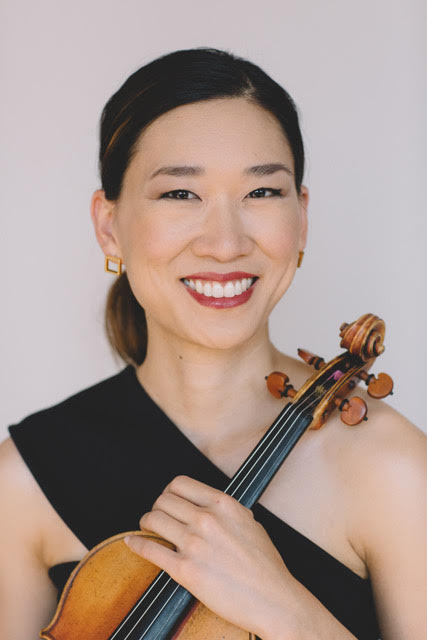 Yvonne Lam holding her violin.